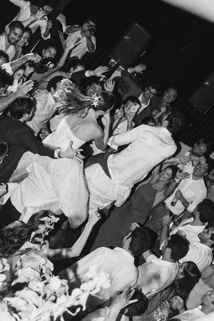 Black and white image of a lively dance floor crowd at a concert or club showing people dancing energetically.