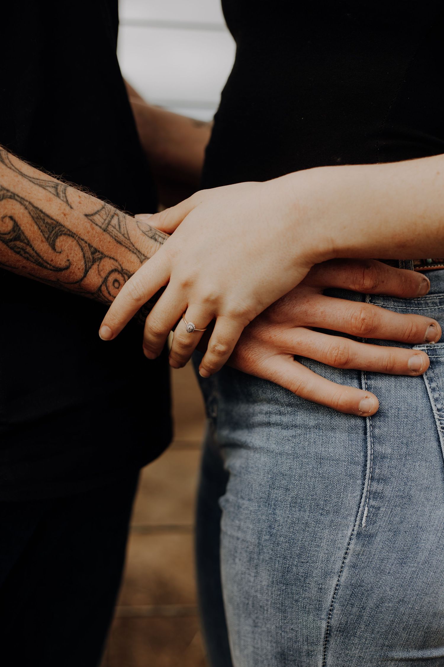 Close-up view of hands with tattoos against faded denim jeans showing multiple cropped angles.