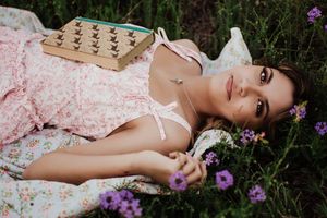 A romantic vintage-inspired portrait among purple wildflowers in a meadow. Tandy Hills