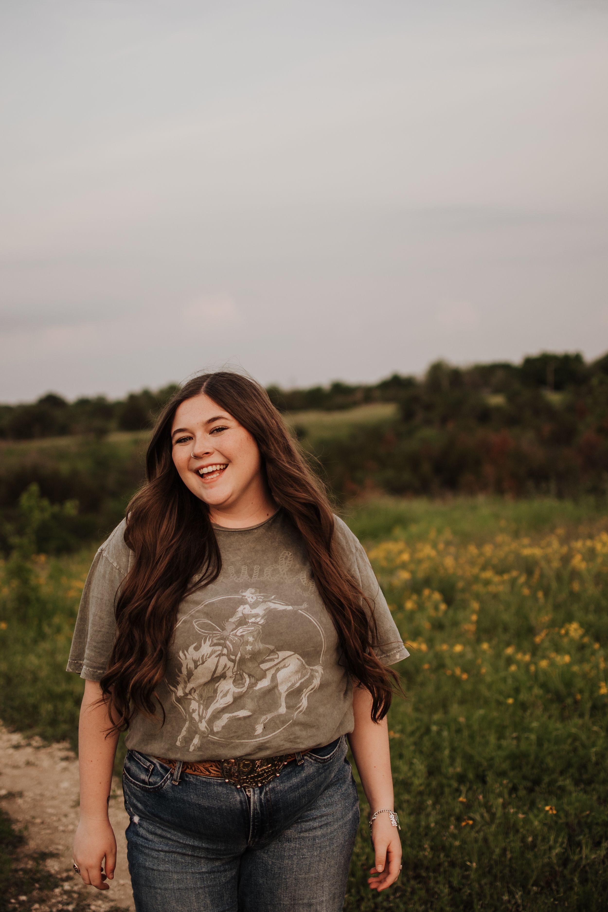 A casual outdoor portrait in a field of yellow wildflowers at sunset.  Dfw Senior Session