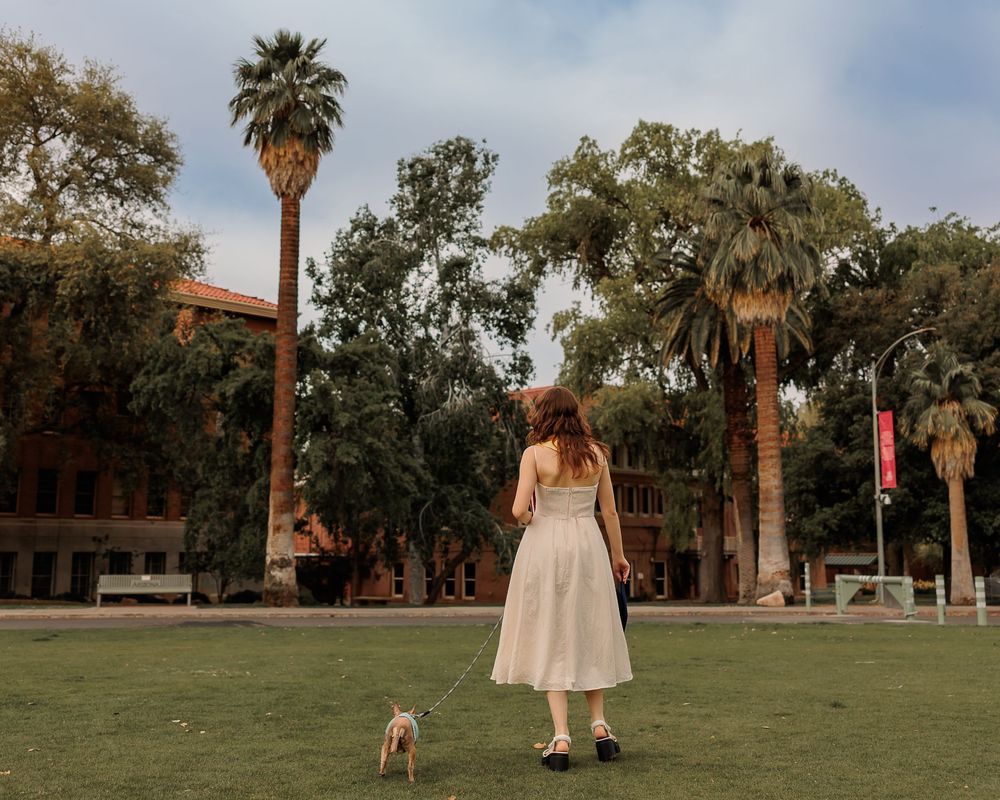 University of Arizona grad with dog on campus – UArizona graduation pictures at Old Main with flowers