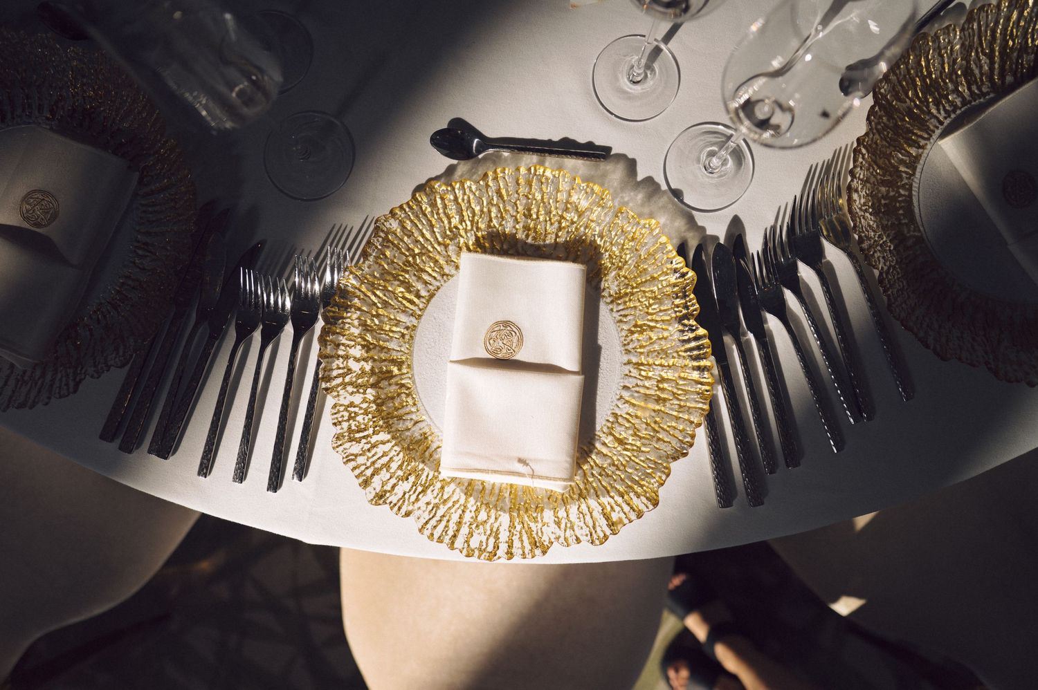 Modern geometric paper art installation made from black and white layered forms with golden metallic accents creates depth.