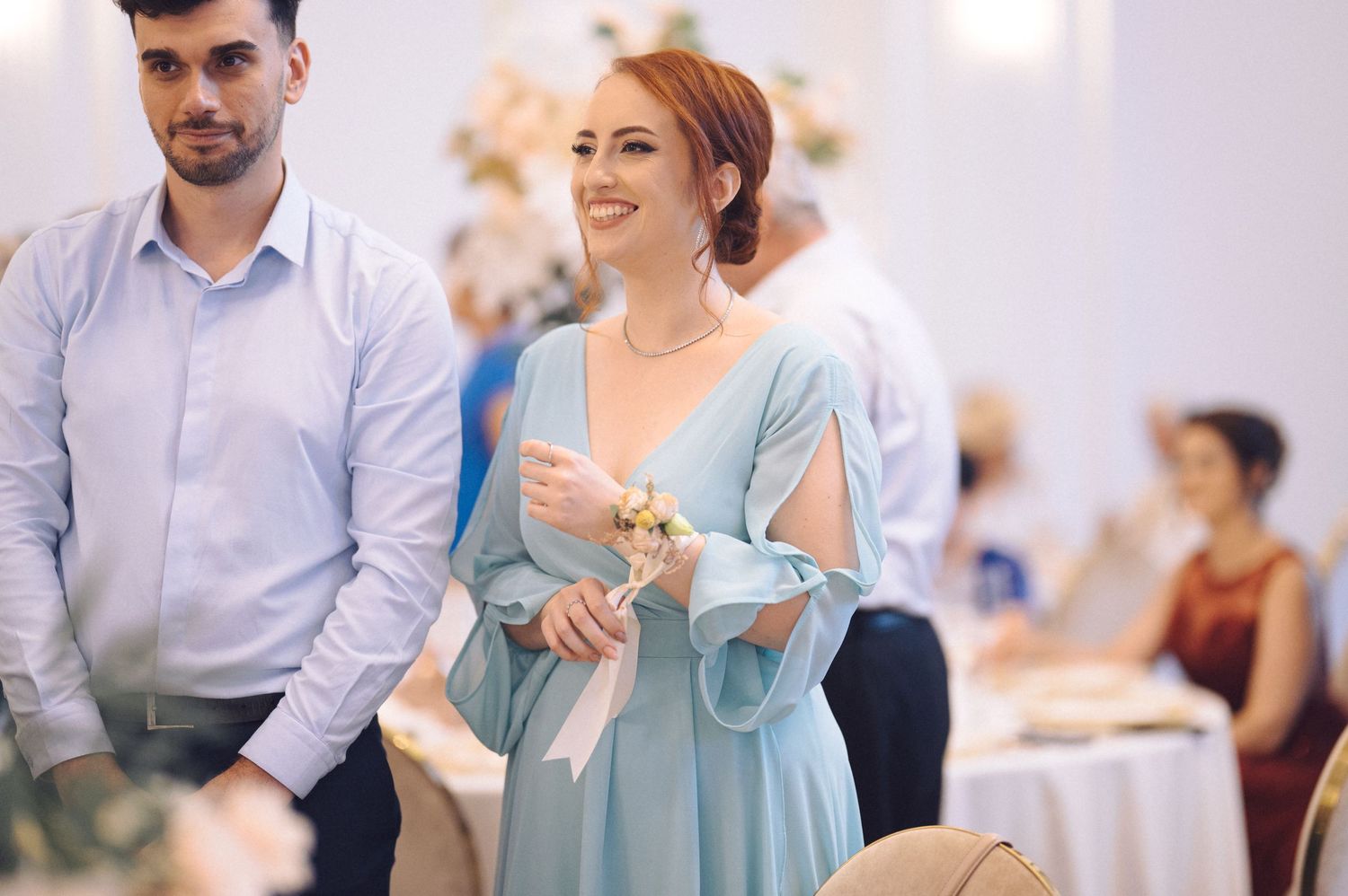 Guests mingling and socializing at an upscale indoor event with bright decor and formal attire.