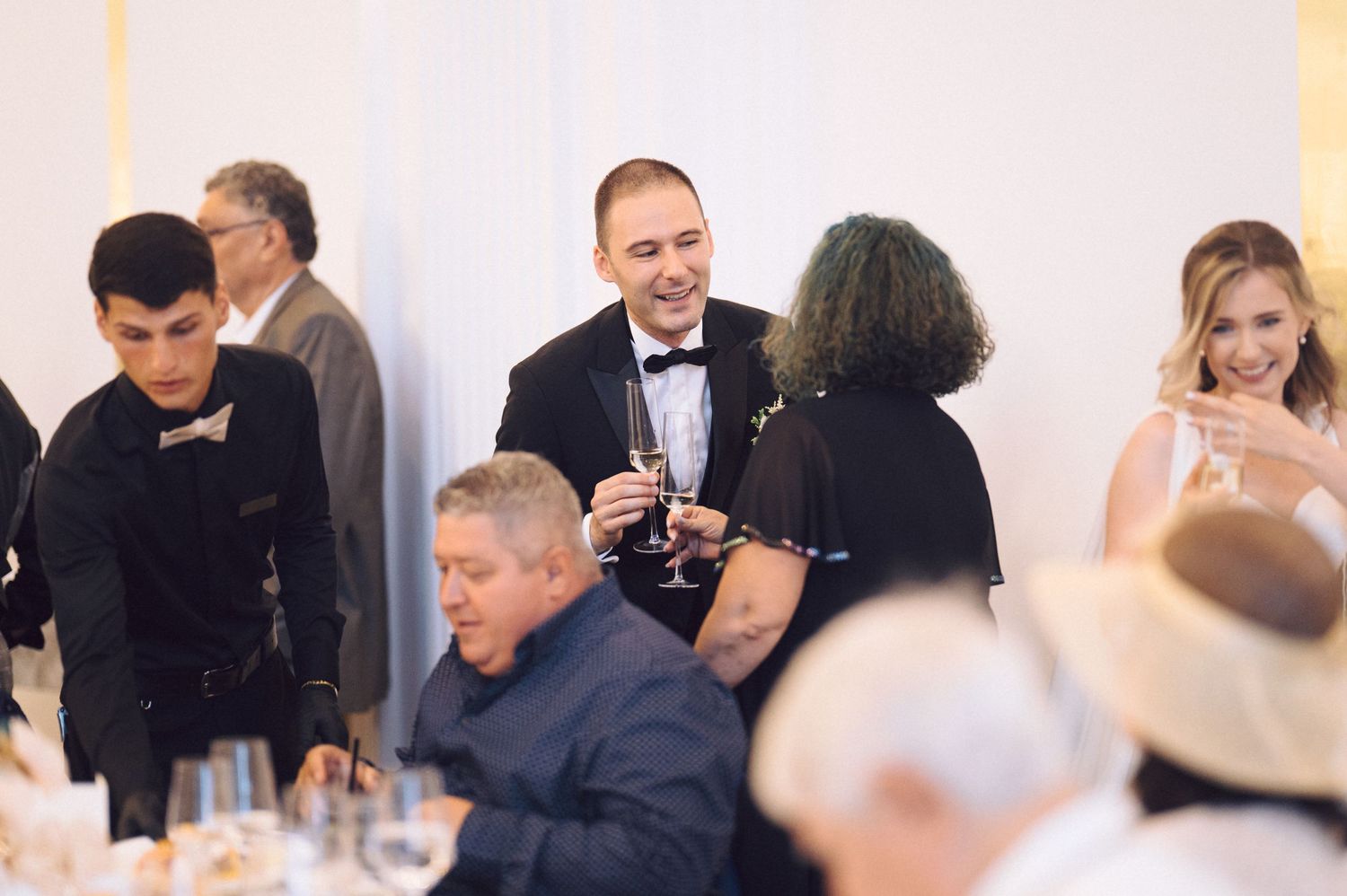 A series of candid shots showing guests dining and socializing at an elegant indoor event.