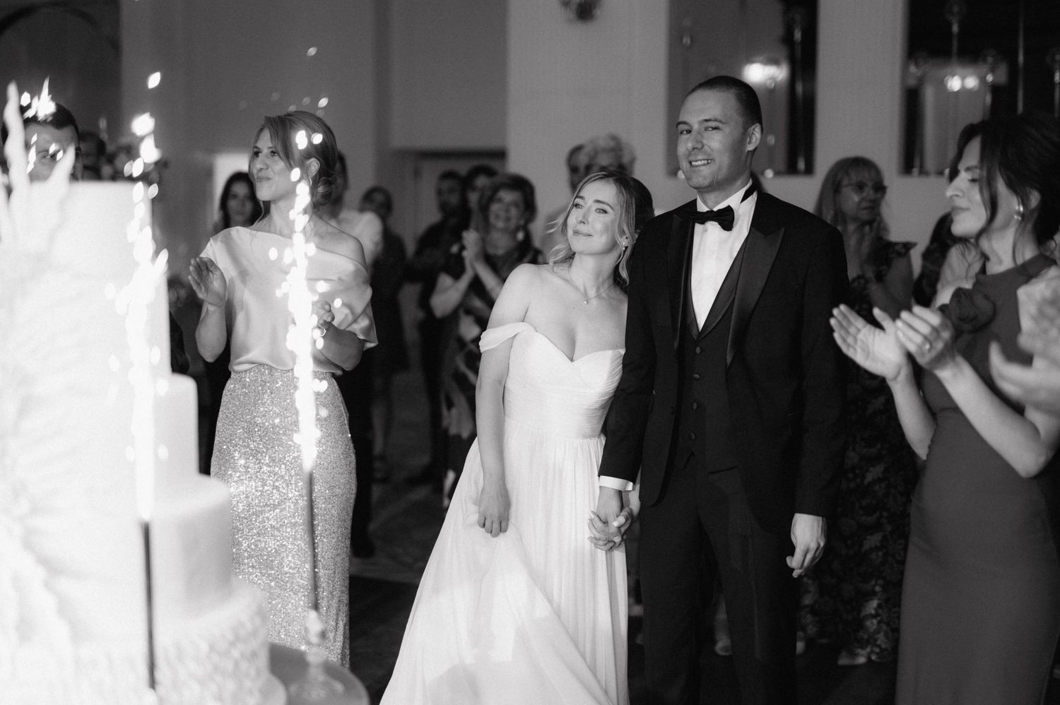 Joyful celebration between a bride and groom dancing together at an elegant wedding reception.