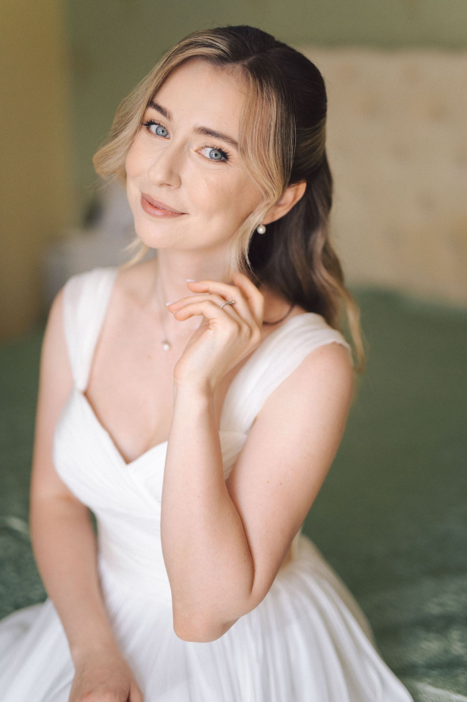 Portrait of someone wearing an elegant white bridal gown with a soft, dreamy lighting effect.