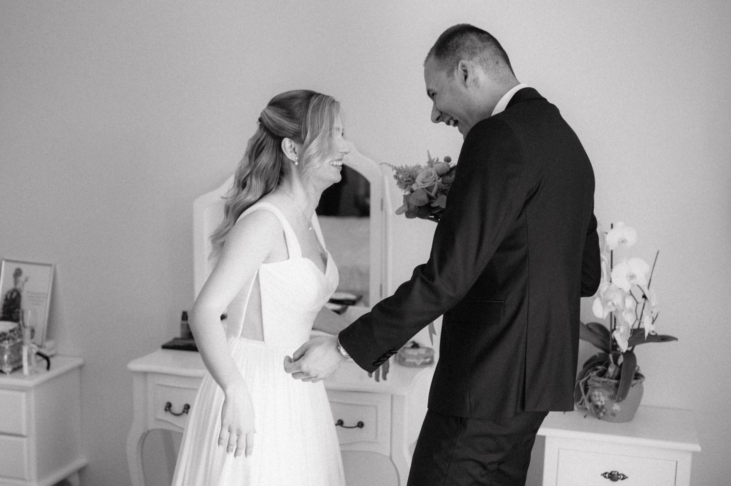 Black and white wedding photo sequence showing intimate moments between a couple during their special day.