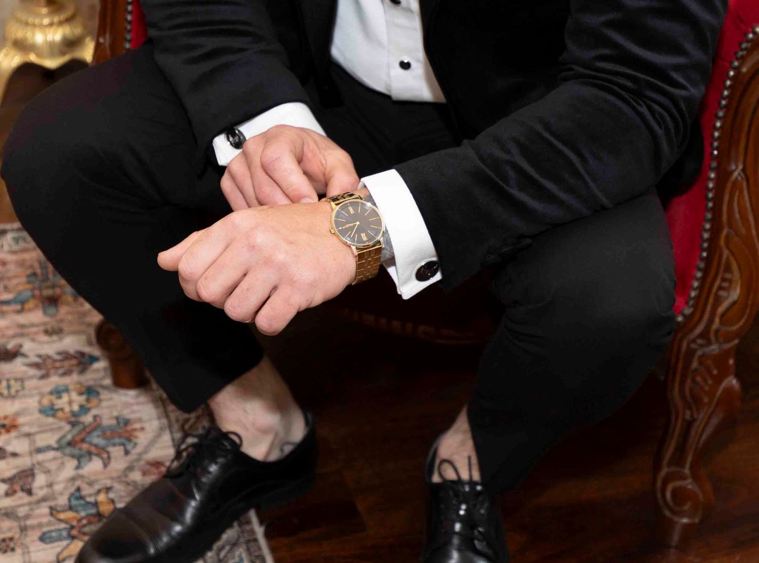 Groom adjusting watch in rustic room at Warrawong Estate Victoria