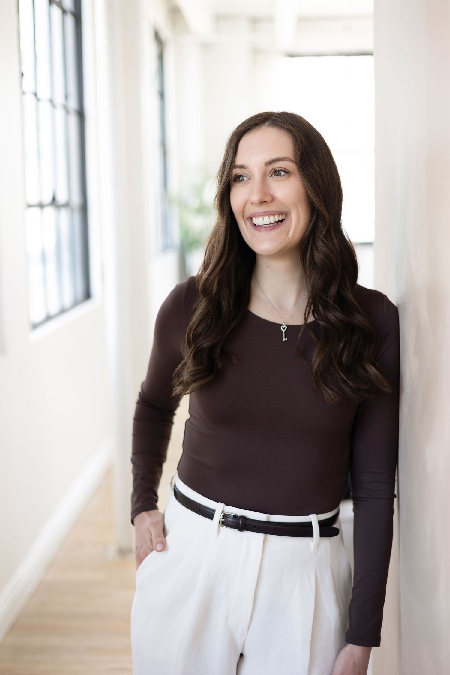 Client changing from corporate blazer to casual outfit during personal branding photoshoot in London Ontario