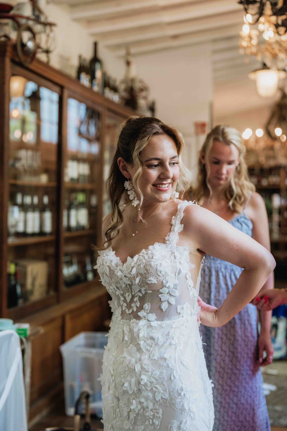 Bridal party getting ready in a rustic venue with warm lighting and elegant decor.