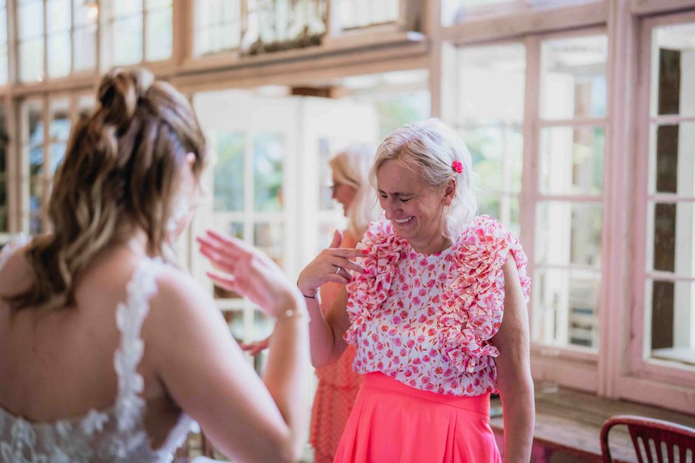 Sun-filled venue interior showing wedding preparation activities.