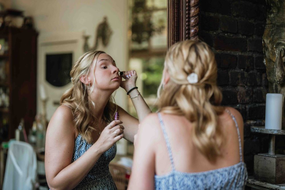 Wedding preparation candid moments in rustic venue with natural lighting.
