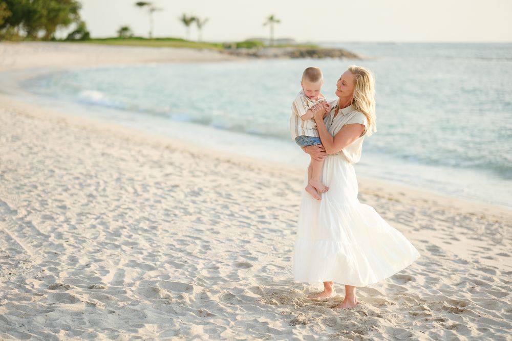 A dreamy beachside wedding photo series showing tender moments captured at sunset on a sandy shoreline.