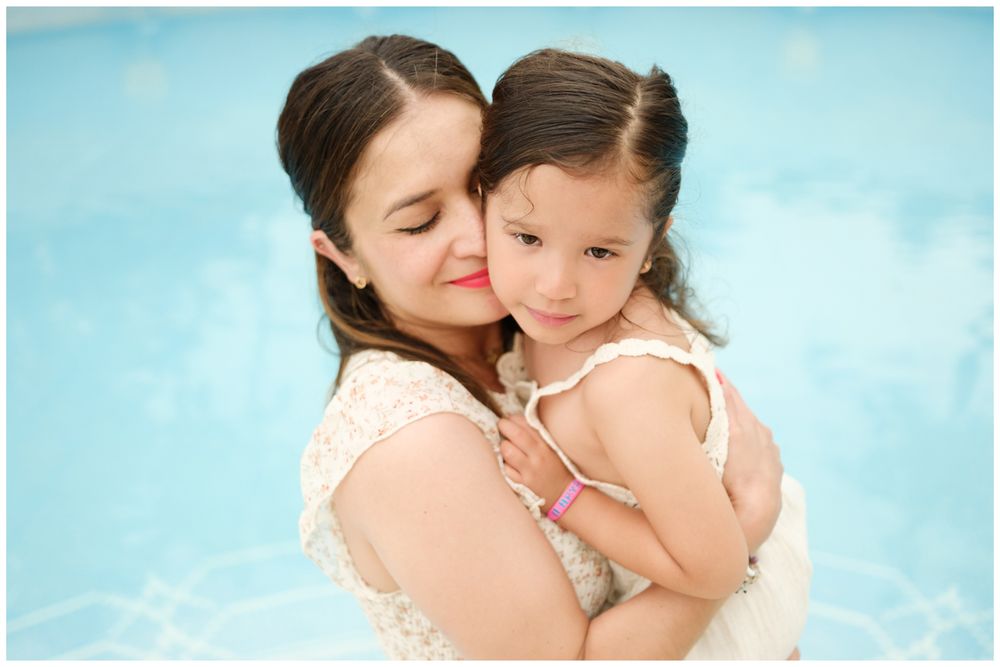 Mother and child sharing tender moments at the beach on a sunny afternoon.