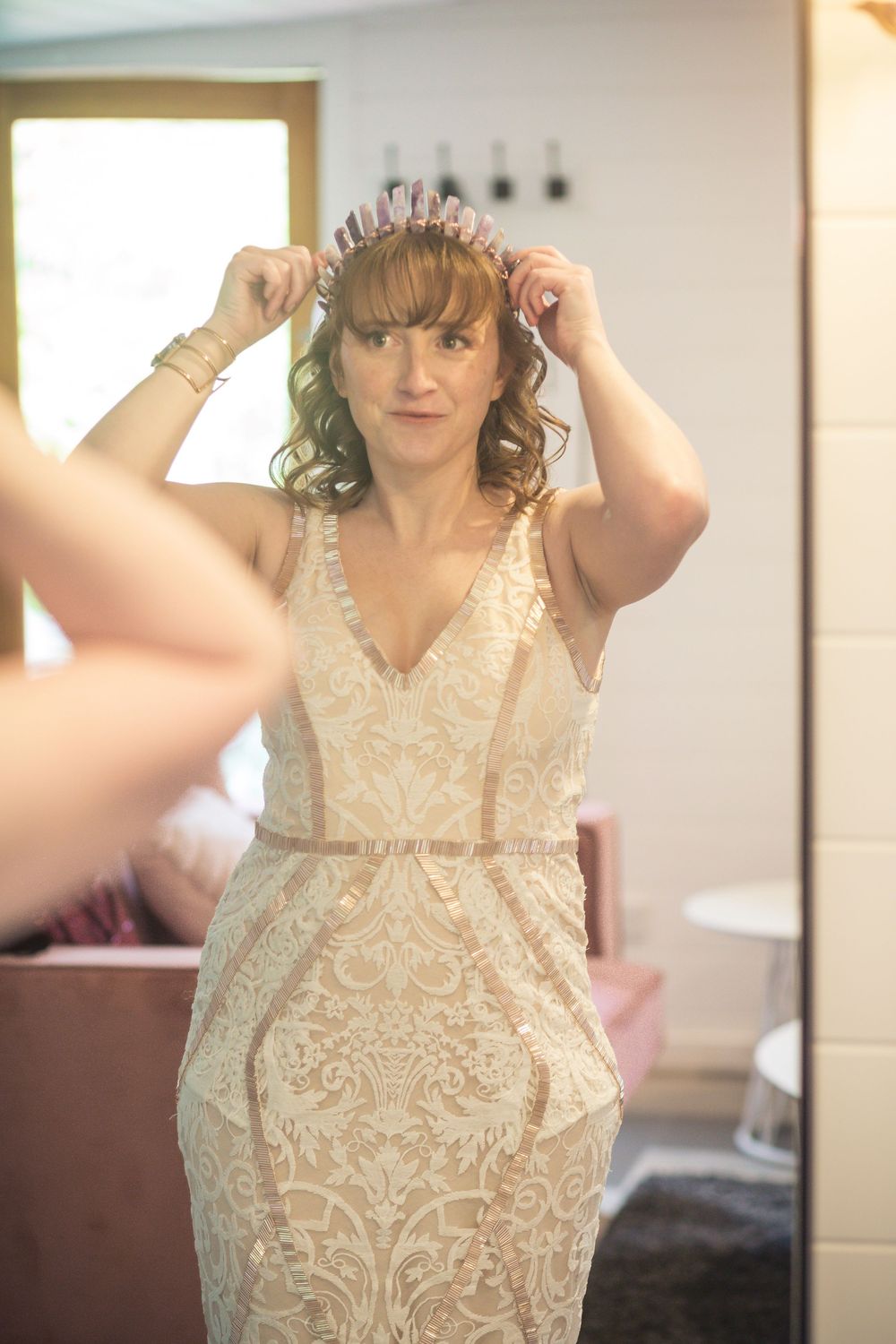Series of photos showing preparation of a bride wearing an elegant cream-colored lace dress with intricate details.