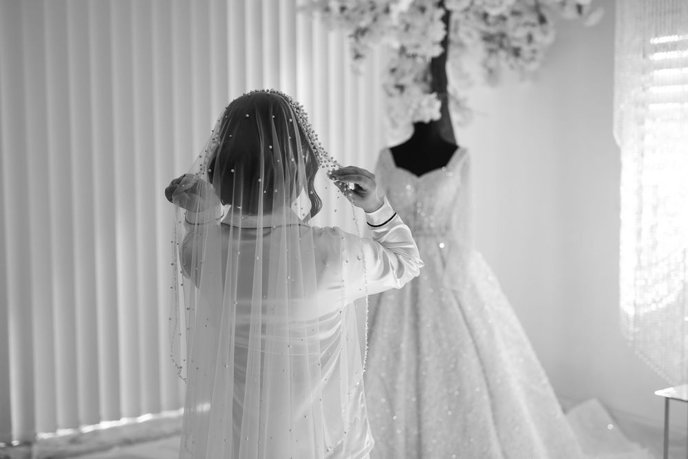 Muslim wedding, brise looking at her wedding dress, with female photographer in western Sydney