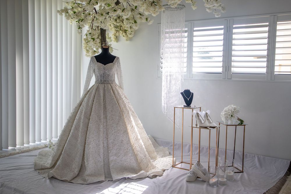 Muslim wedding, brise looking at her wedding dress, with female photographer in western Sydney