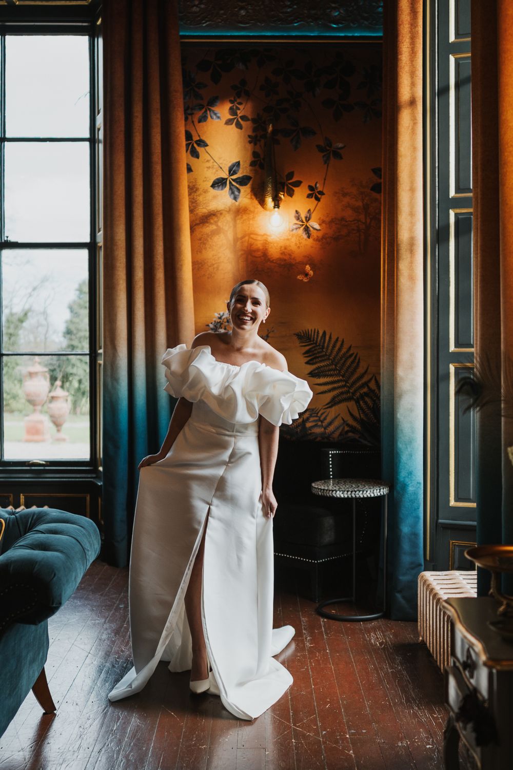 A series of artistic wedding dress movement photos in an elegant room with dark teal walls and floral wallpaper.