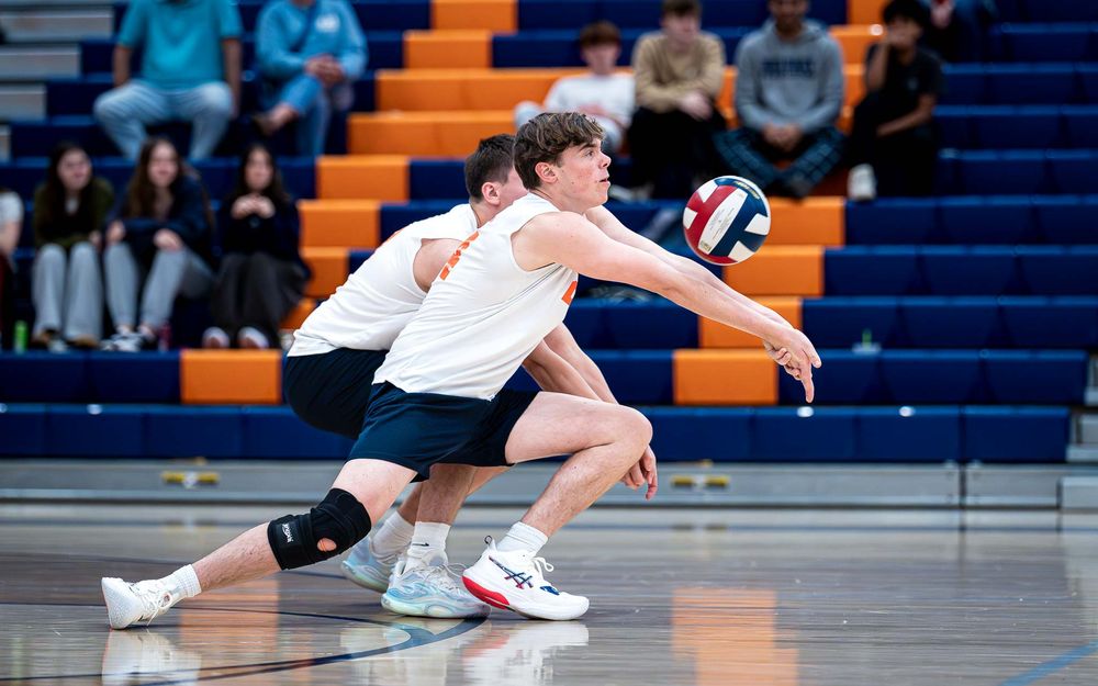 Hershey Trojans boys volleyball players dig vs Mechanicsburg Wildcats at Hershey High School, April 2026 — SportsFox Photography