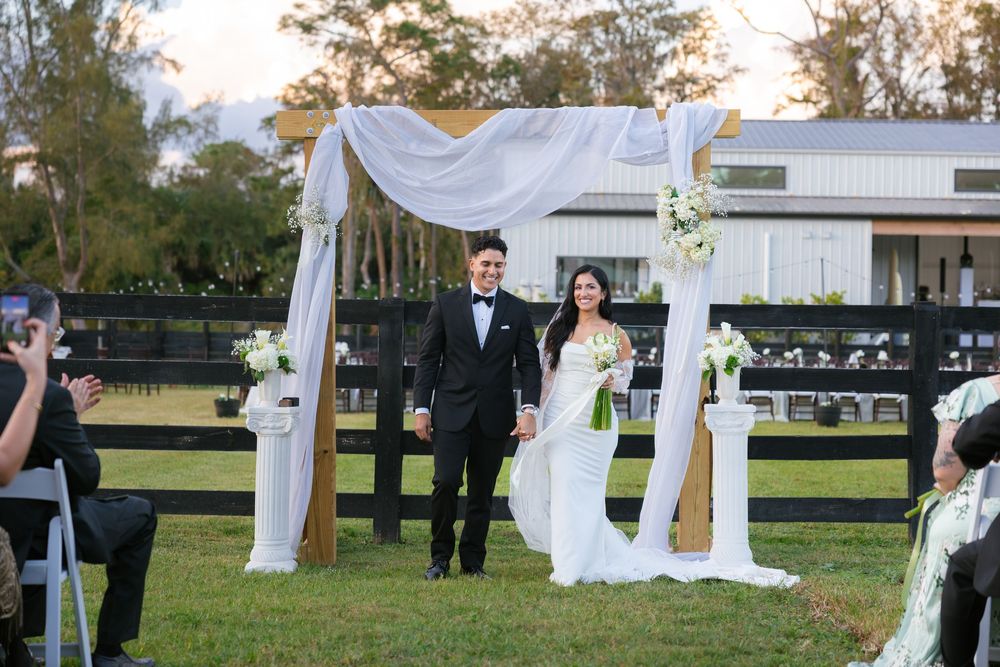 bride and groom just married at barn wedding at the ranch 22 in lake worth