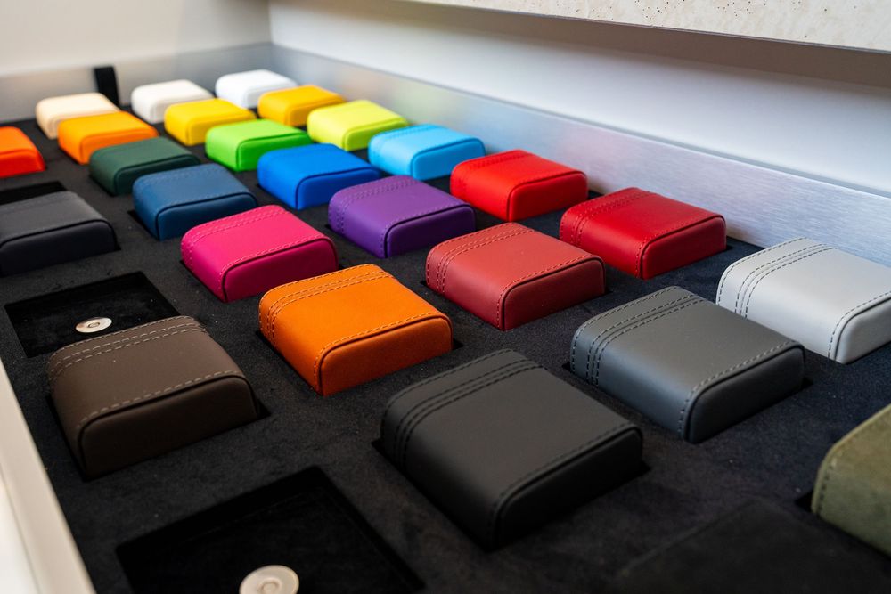 Display of colorful leather interior swatches in various hues for custom Lamborghini vehicle configuration.