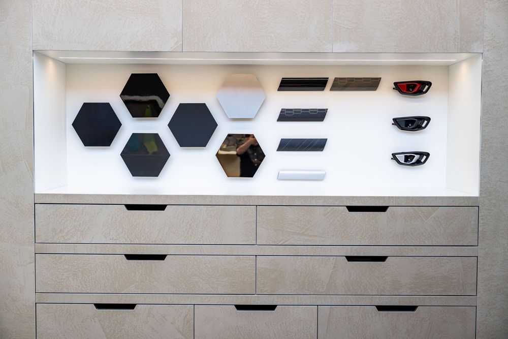 Lamborghini dealership customisation wall display featuring hexagonal material swatches and trim samples.