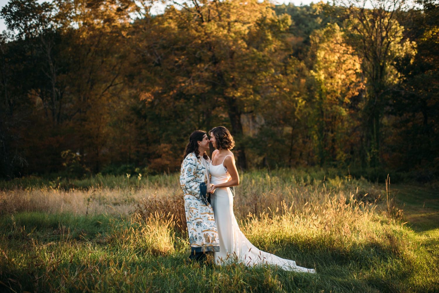 Couple embracing in meadow during wedding at Montague Retreat Center in Western Massachusetts by photographer Rachel Maeve