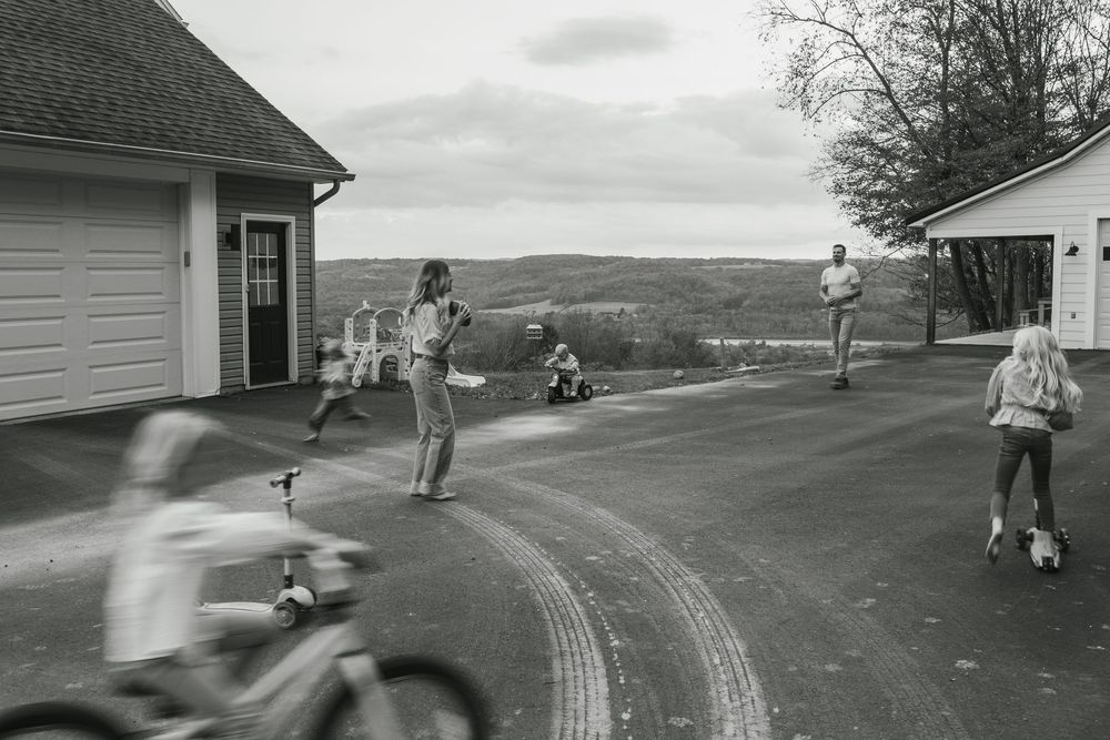 A series of black and white photographs showing skateboarders performing tricks on a curved ramp or road.