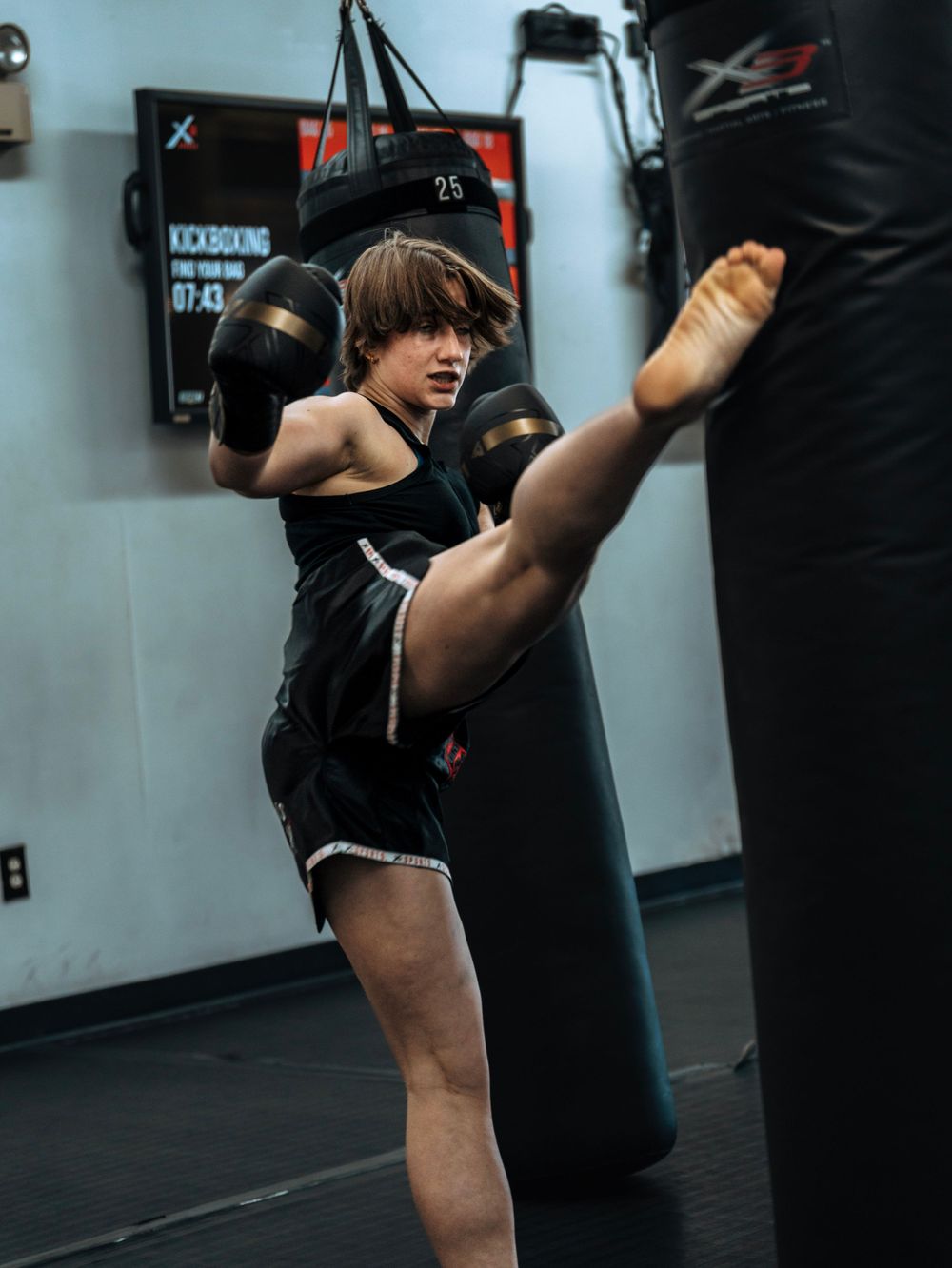 Senior Portrait Session showcasing hobbies and sports interest like Muy thai. Sports Photography. Take at X3 sports in North Marietta.