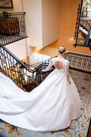 A white wedding dress train dramatically sweeps across a patterned floor in a series of connected photos.