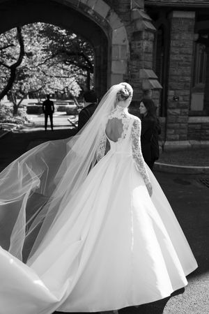 A flowing white wedding dress twirls gracefully in a series of artistic black and white photographs outdoors.