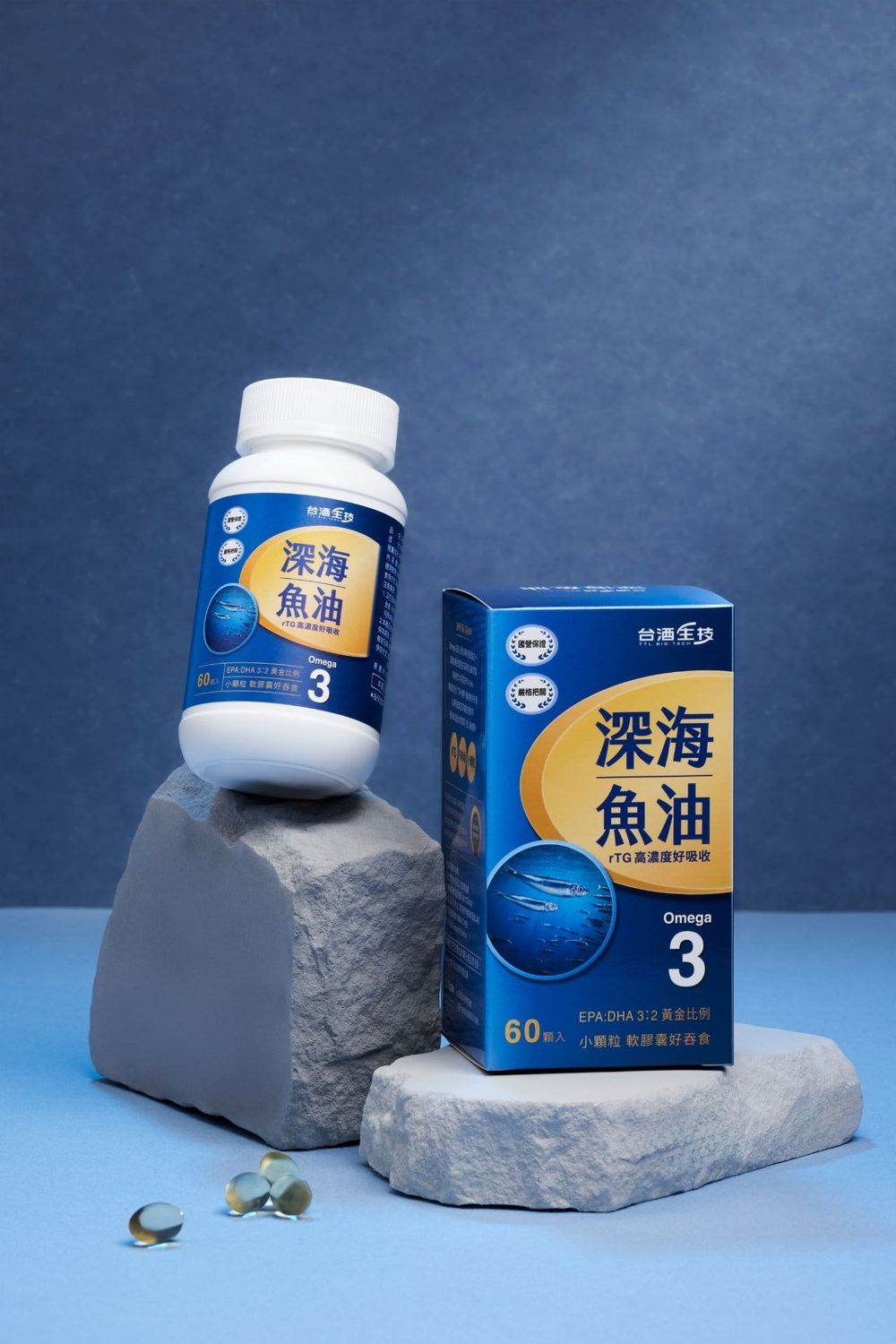 Deep sea fish oil Omega-3 supplement bottle and box displayed on stone props against blue backdrop.