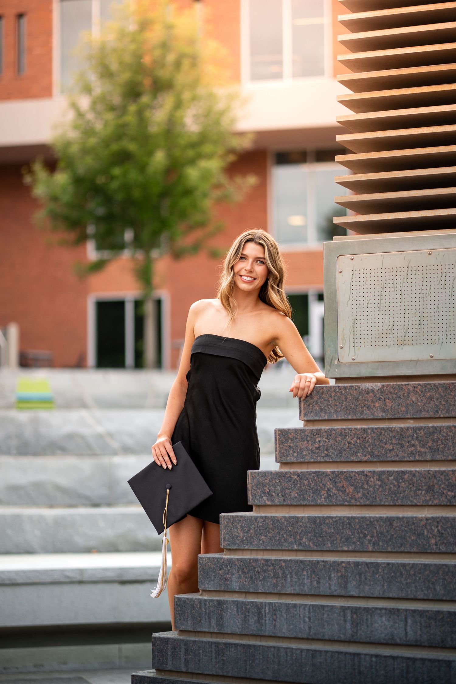 Smiling graduate poses for the best Atlanta grad photos at Georgia Tech with portraits by Pierre The Pear Photography