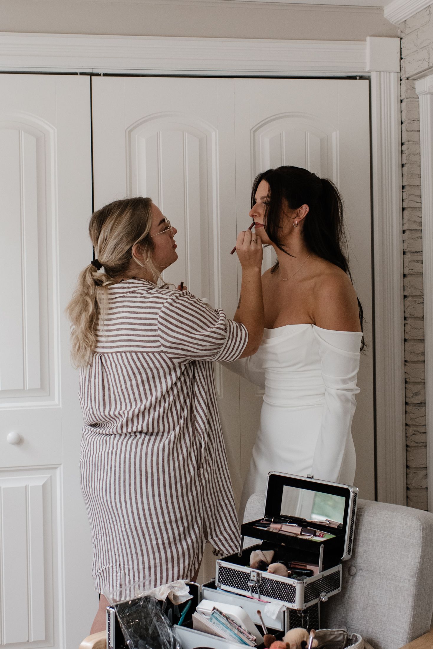 Makeup artist in striped shirt applying cosmetic products in sequence of professional beauty preparation shots.