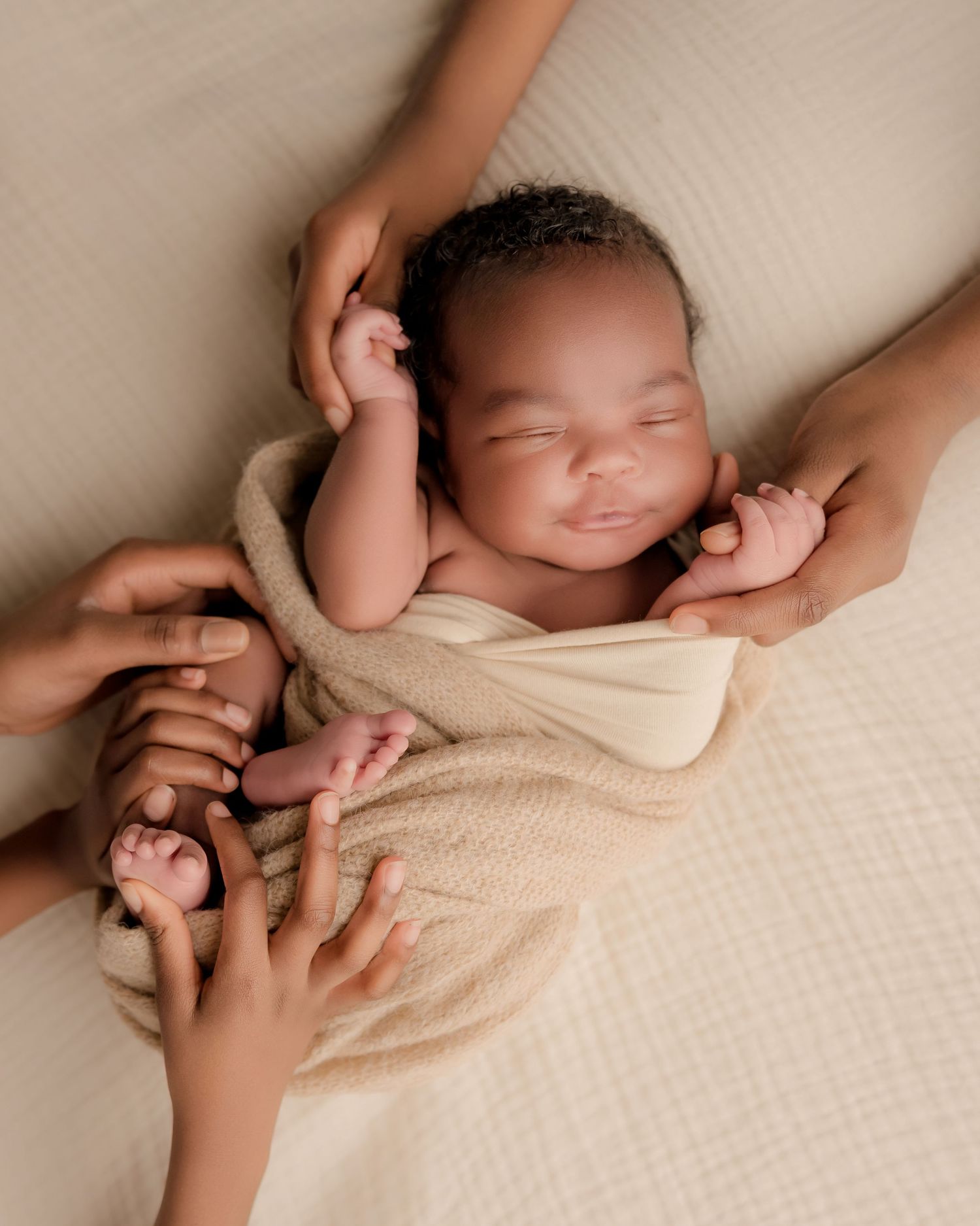 A series of peaceful newborn photography poses on a wooden bed with soft beige wrapping and neutral tones.