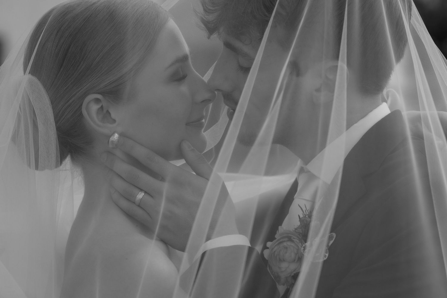A joyful couple shares candid moments in black and white wedding photos showing natural laughter and connection.