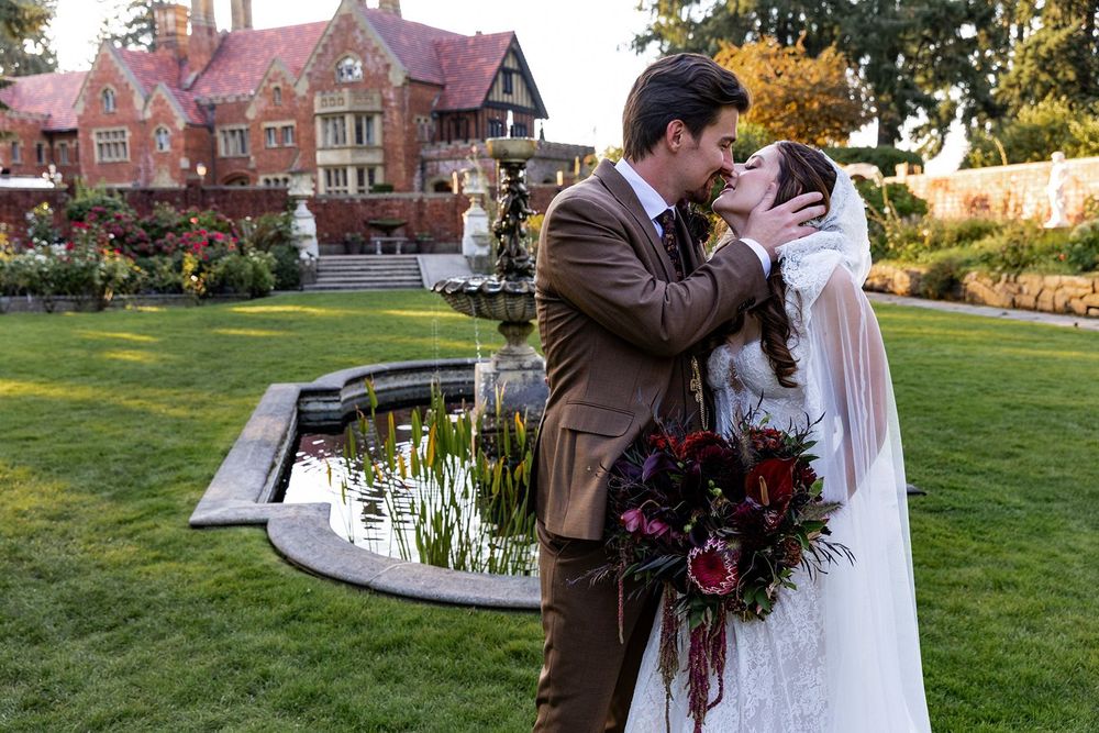 bride and groom kissing in the garden at the thornewood castle wedding ceremony location