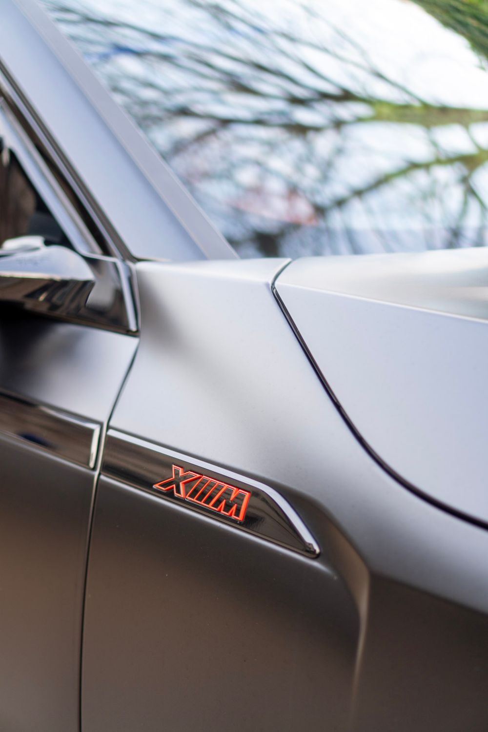 Close-up sequence showing a car's A-pillar design detail with red trim accent in progressive macro shots.
