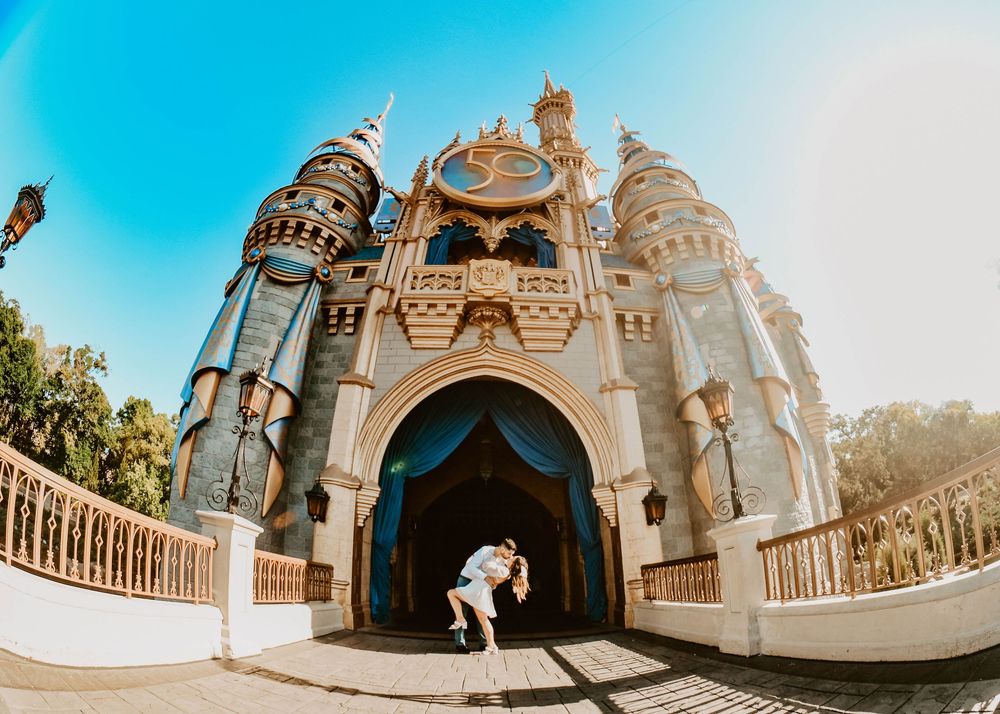 Disney-inspired wedding photography, couple kissing in front of Cinderella Castle in Central Florida.