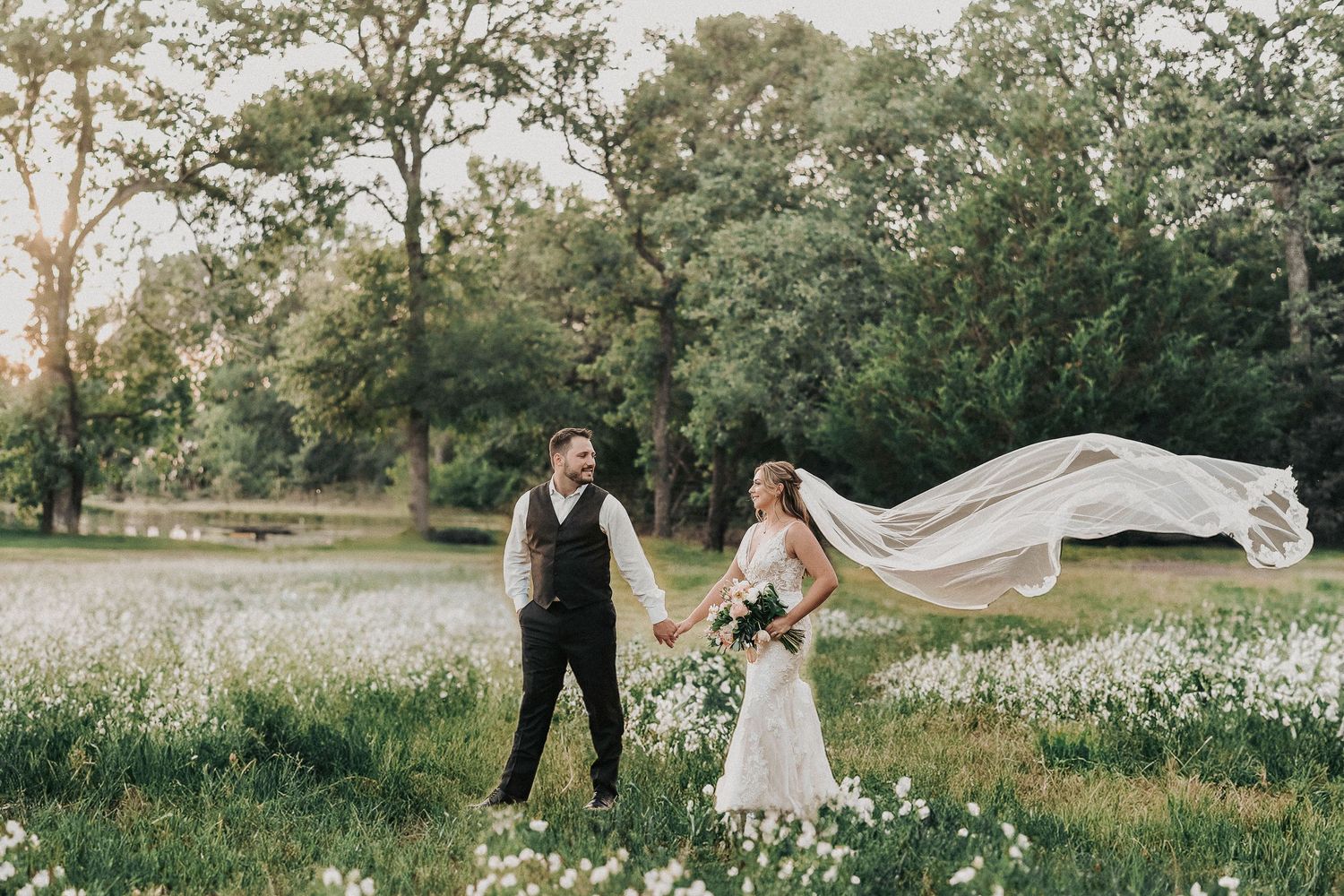 Timeless spring wedding couple portraits surrounded by natural greenery and oak trees.