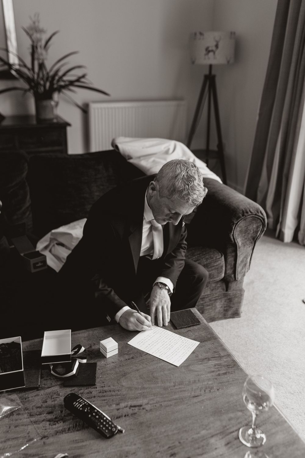 Black and white photos show someone signing documents at a table during a wedding ceremony.