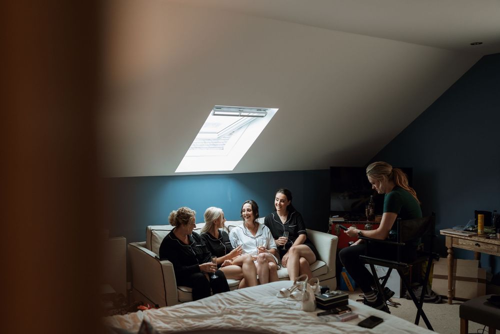 Group gathered in dimly lit attic space for intimate gathering or meeting.