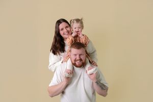 A series of five candid photos showing playful interactions between two people in white shirts against a beige background.