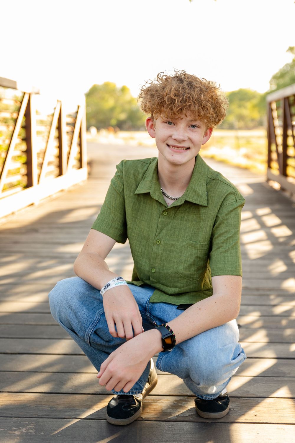 boy on bridge smiling at camera