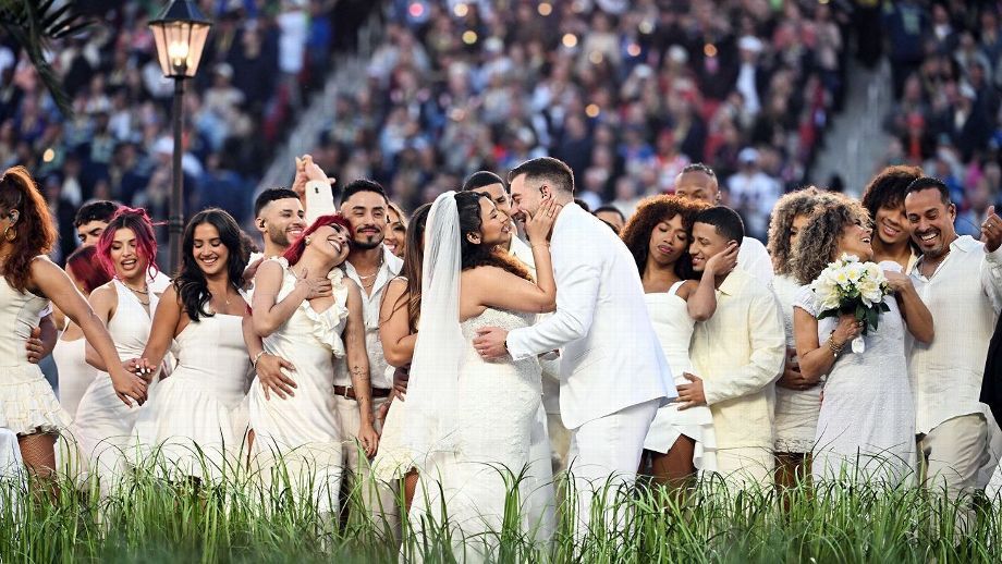 Tennis players and officials gather for a group photo at Wimbledon wearing traditional all-white attire.