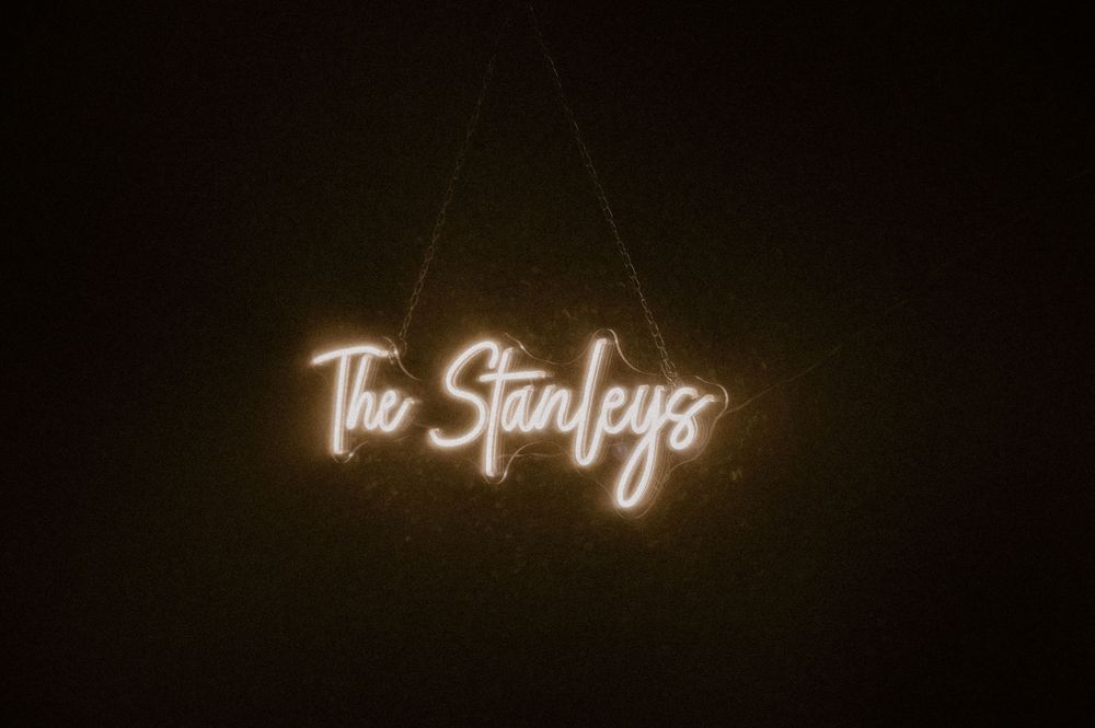 Glowing neon text signs illuminate a dark background in a sequence of artistic photographs.
