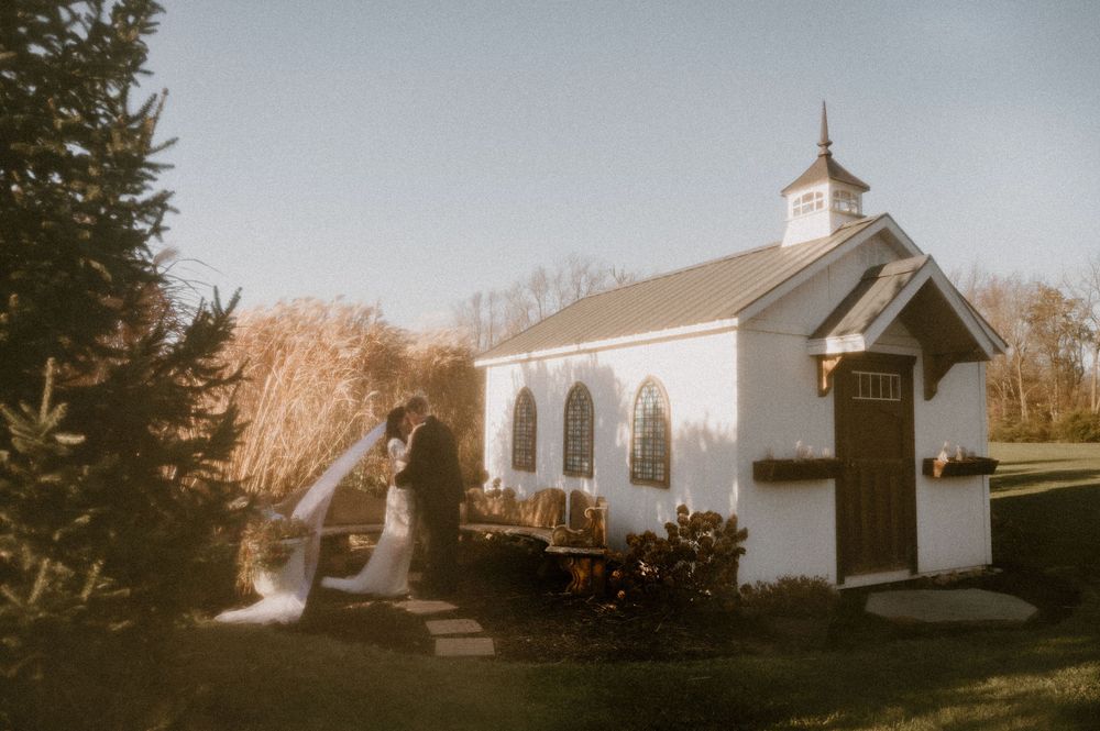 A series of white country church buildings photographed in a vintage style with warm lighting and evergreen trees.