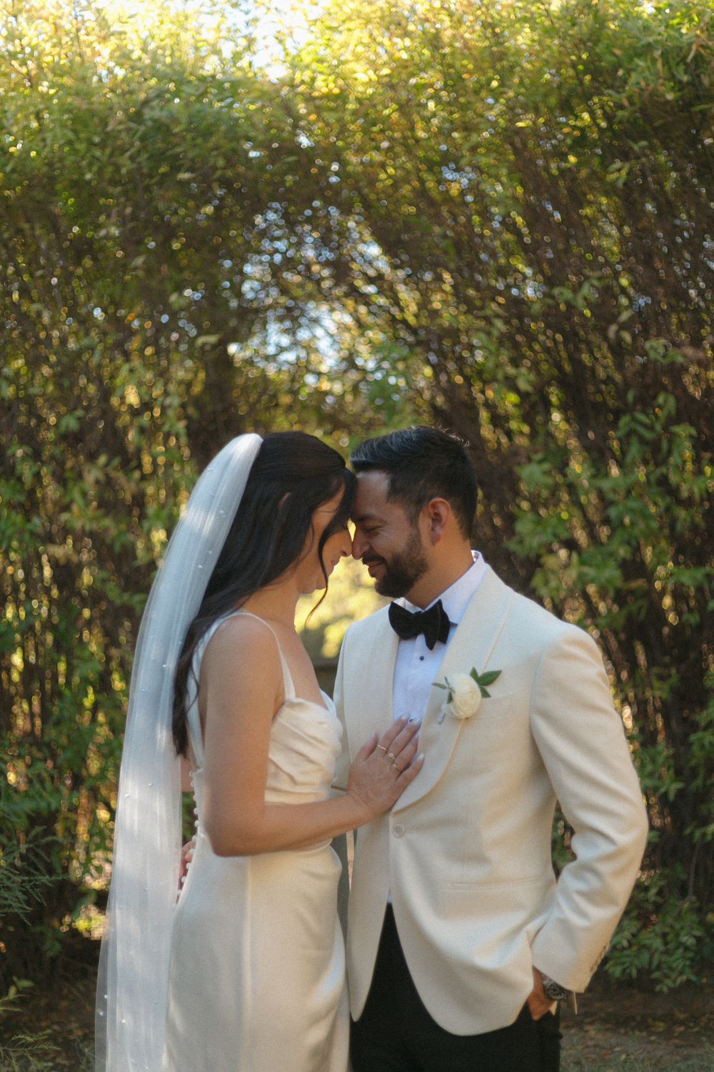 A romantic wedding photo sequence showing tender moments between a couple in formal attire against a lush garden backdrop.