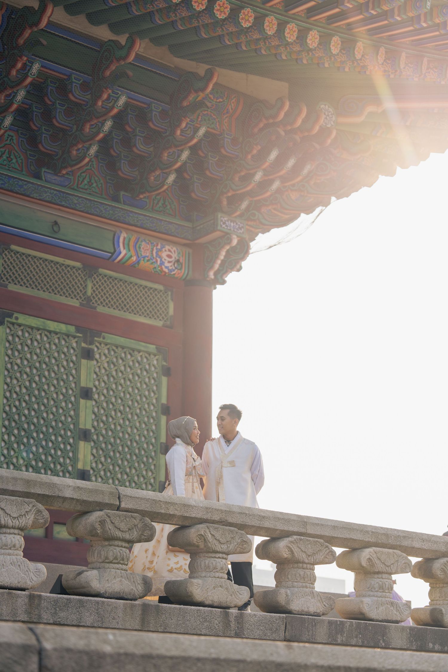 Ancient Korean temple architectural details showing ornate painted wooden beams and stone carvings under traditional eaves.