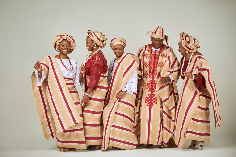 A sequence of photos showing traditional Nigerian costumes with red and white embroidered patterns displayed as agbada, gele, fila and ipele